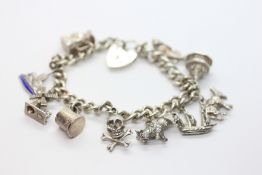 A SILVER CHARM BRACELET AND 10 ASSORTED CHARMS.