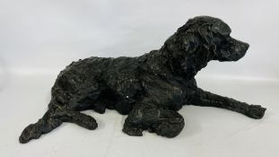 A BRONZED RESIN LIFE SIZE MODEL OF A RECLINING SPANIEL, LENGTH 78CM.