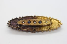 A 15CT GOLD BAR BROOCH OF NAVETTE FORM SET WITH THREE SMALL DIAMONDS AND TWO SAPPHIRES.