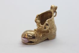 A 9CT GOLD CHARM IN THE FORM OF A BOOT.