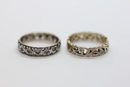 A 9CT GOLD STONE SET ETERNITY RING + A YELLOW AND WHITE EXAMPLE.