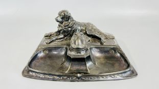 A VINTAGE SPELTER INKSTANDISH SURMOUNTED BY A RECLINING DOG BEARING IMPRESSED MAKERS MARK 5518