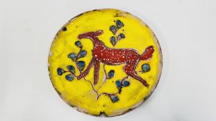 A GLAZED STUDIO POTTERY PLATE DEPICTING A RED FOAL ON A YELLOW GROUND BEARING SIGNATURE AR ROUS