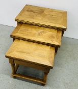 A GRADUATED NEST OF THREE BAKER BEDFORD FLAGSTONE OCCASIONAL TABLES.
