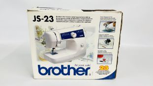 A BROTHER JS-23 SEWING MACHINE AND FOOT PEDAL (BOXED) - SOLD AS SEEN.