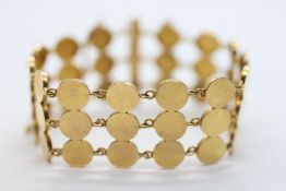 AN UNUSUAL YELLOW METAL TRIPLE STRAND BRACELET WITH PIN CLASP.