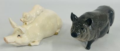 A ROYAL DOULTON GREY POT BELLIED PIG + A BESWICK SOW PIG AND PIGLET STUDY.