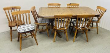 SOLID HONEY PINE EXTENDING DINING TABLE ON TWIN PEDESTAL SUPPORTS COMPLETE WITH A SET OF 8 MATCHING