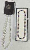A COSTUME NECKLACE, THE IRIDESCENT STONES DIVIDED BY ROD AND BALL BATONS, THE CLASP MAGNETIC,