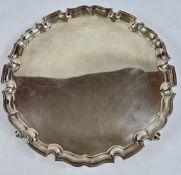 SOLID SILVER SALVER WITH SHAPED EDGE STANDING ON FOUR SCROLLED FEET, LONDON ASSAY, MAKER E.