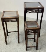 NEST OF 3 HARDWOOD ORIENTAL DESIGN TABLES WITH GLASS INSET TOPS.
