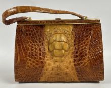 A VINTAGE CROCODILE SKIN HANDBAG.