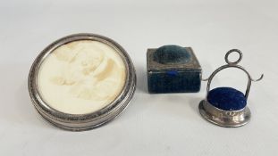 A SILVER PHOTOGRAPH FRAME AND TWO SILVER PIN CUSHIONS.