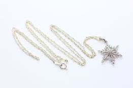 A WHITE METAL CHAIN MARKED 925 SUPPORTING A SNOWFLAKE PENDANT SET WITH MULTIPLE TINY DIAMONDS,
