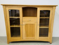 A MODERN LIGHT OAK TWO DOOR CABINET WITH CENTRAL DRAWER AND CUPBOARD BELOW, W 176CM, D 48CM,