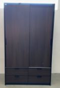 AN IKEA DESIGNER SLIDING TWO DOOR WARDROBE WITH FOUR DRAWER BASE.