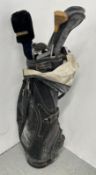 A BEN HOGAN GOLF BAG CONTAINING AN ASSORTMENT OF IRONS, WOODS AND ACCESSORIES.