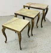 A GRADUATED SET OF THREE GILT METAL FRAMED OCCASIONAL TABLES WITH ONYX TOPS, THE LARGEST 51 X 31CM.