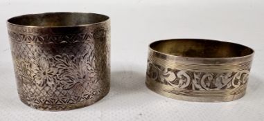 TWO ODD SILVER NAPKIN RINGS.