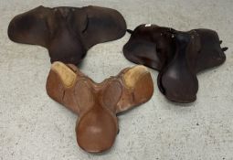THREE VINTAGE LEATHER SADDLES.