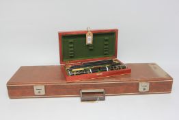 AGUINAGA HARDWOOD CASED 12 GAUGE SHOTGUN CLEANING KIT AND BROWN REXINE COVERED SHOTGUN MOTORING