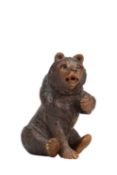 A 19TH CENTURY BLACK FOREST CARVED LINDENWOOD BEAR INKWELL