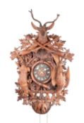 A LARGE 19TH CENTURY BLACK FORREST CARVED WALNUT HANGING CUCKOO CLOCK