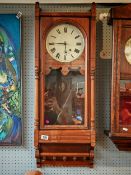 Walnut Cased Edwardian wall clock with roman numeral face, turned supports.