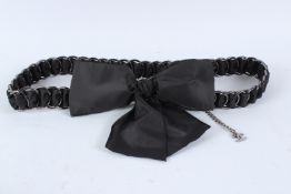 A CHANEL METAL LOUPE AND SATIN MATERIAL BELT WITH BOW, complete with bag and certificate of