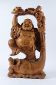 A LARGE CHINESE CARVED WOOD FIGURE OF A HAPPY BUDDHA, with two boy attendants and a frog. 62cms