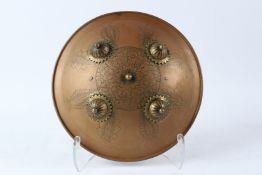 A 19TH CENTURY INDIAN ENGRAVED BRASS SHIELD with gilded bosses. 34cms diameter.