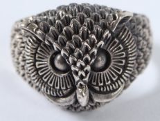 A SILVER OWL HEAD RING.