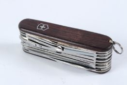 A SWISS ARMY KNIFE, with wooden scales.