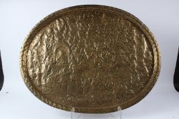 A VERY LARGE 19TH CENTURY INDIAN BRASS TRAY depicting a scene from the Ramayana. 73cms x 56cms.