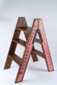 A PAIR OF NOVELTY WOODEN CHAMPAGNE STEPLADDERS. 80cms high.