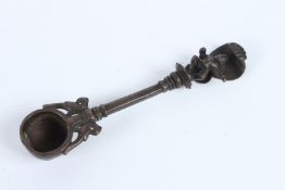 AN 18TH CENTURY MUGHAL INDIAN BRONZE OIL SPOON with Krishna finial. 17cms long.