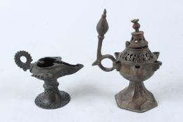 TWO EARLY ISLAMIC BRONZE OIL LAMPS. 16.5cms and 9cms high.