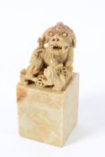 A CHINESE SOAPSTONE FOO DOG. 14cms high.