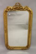 A GILTWOOD PIER MIRROR, with ribbon cresting. 5ft 0ins high x 2ft 8ins wide.