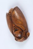 A CARVED HARDWOOD CICADA. 7cms.