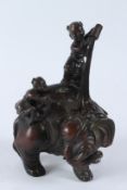A GOOD BRONZE ELEPHANT with two figures. 30cms high.