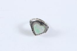 A SILVER AND JADE HEART SHAPED RING.