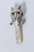 A SILVER CAT RATTLE.