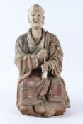 A LARGE PAINTED WOOD AND STUCCO FIGURE OF A LOUHAN, Ming Dynasty (1368 - 1644), modelled seated
