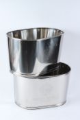 A PAIR OF POLISHED METAL CHAMPAGNE WINE COOLERS. 42cms wide.