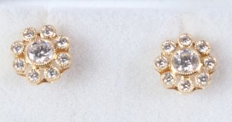 A PAIR OF 18CT YELLOW GOLD AND DIAMOND FLOWER HEAD CLUSTER EAR STUDS.
