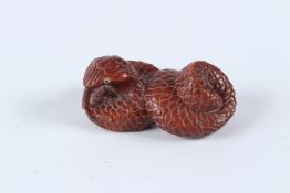 A HARDWOOD SNAKE NETSUKE. Signed.