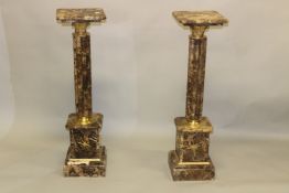 A PAIR OF VARIEGATED GREY MARBLE AND ORMOLU MOUNTED PEDESTAL COLUMNS. 3ft 4ins high x 11ins wide.