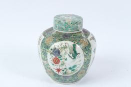 A 19TH CENTURY GINGER JAR AND COVER with four panels of birds, flowers etc. 19cms high.
