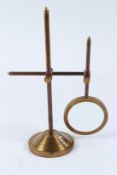 A MAGNIFYING GLASS on a stand.